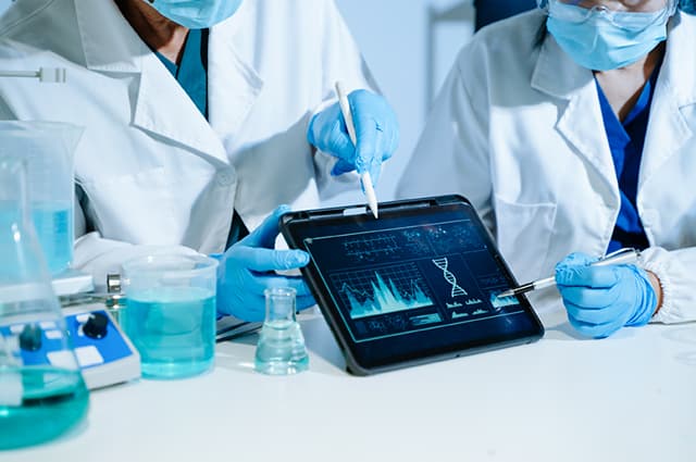 Clinicians reviewing a patient scan on a tablet